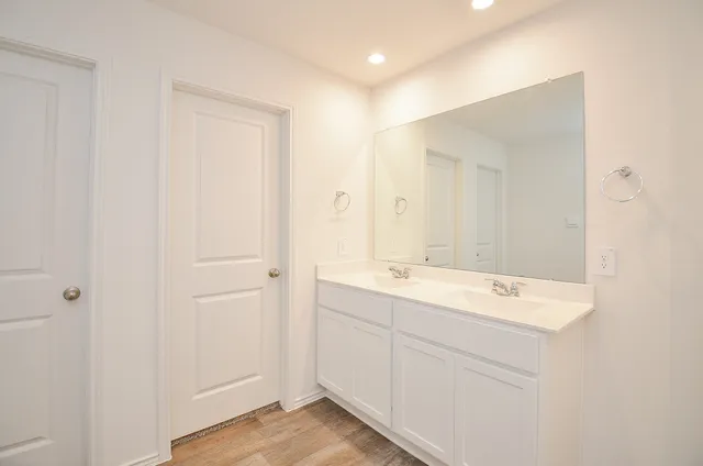a view of bathroom with a sink mirror and
