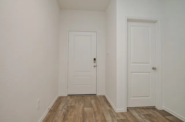a view of a room with wooden floor