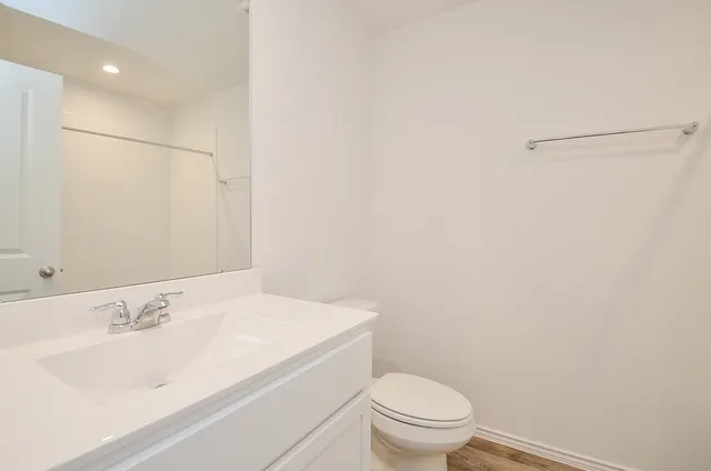a bathroom with a sink toilet and vanity