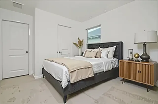 a bed room with a bed and a lamp