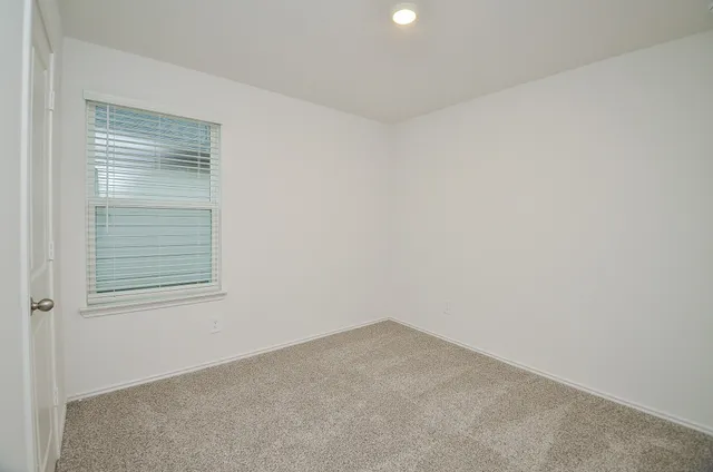 a bedroom with bed and a window