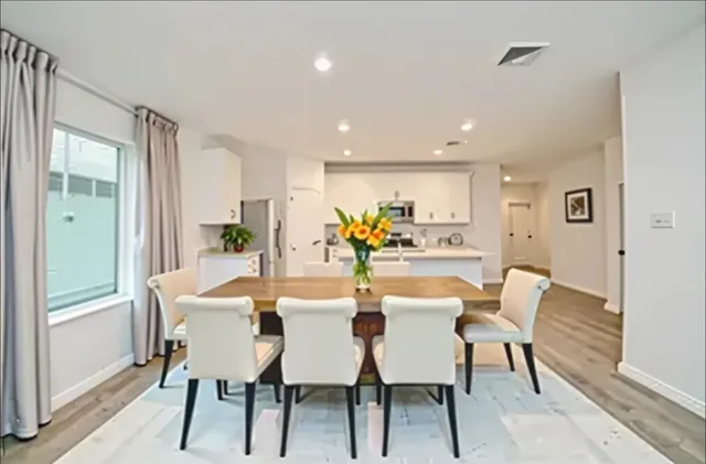 a view of a dining room with furniture window and wooden floor