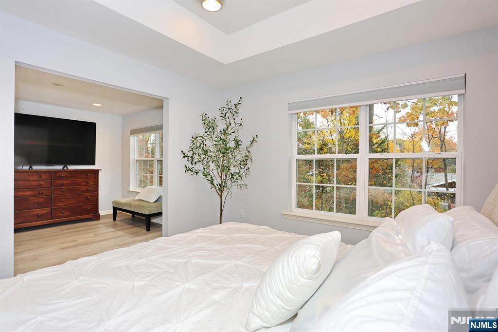 4 Masterson Court, Unit 4 Waldwick, NJ 07463 - Photo 17 of 26 a bedroom with a bed and a large window
