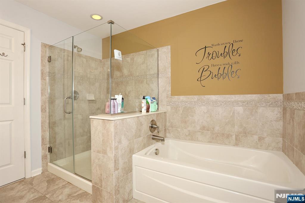 4 Masterson Court, Unit 4 Waldwick, NJ 07463 - Photo 20 of 26 a bathroom with a bathtub and a shower