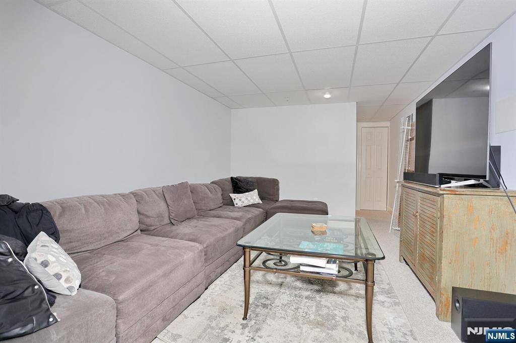 4 Masterson Court, Unit 4 Waldwick, NJ 07463 - Photo 22 of 26 a living room with furniture and a flat screen tv