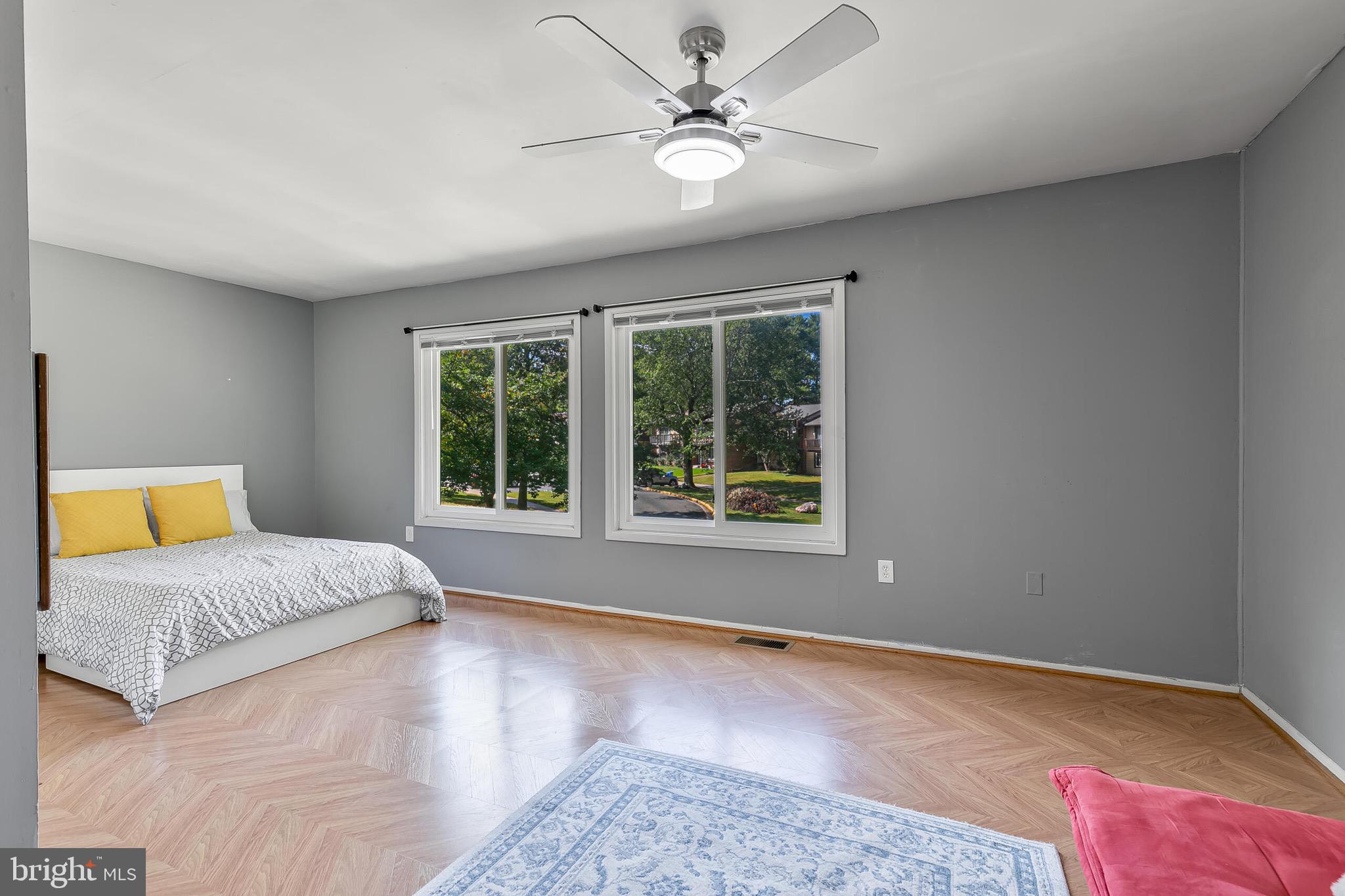 9108 Centerway Road Gaithersburg, MD 20879 - Photo 14 of 33 a spacious bedroom with a large bed and a chandelier