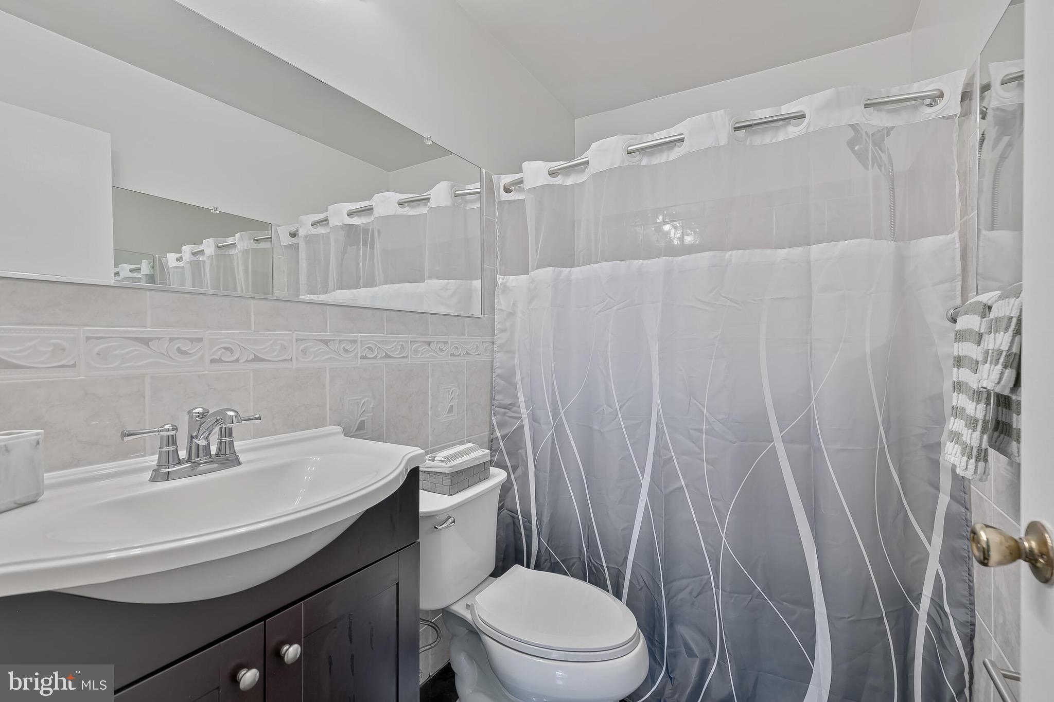 9108 Centerway Road Gaithersburg, MD 20879 - Photo 15 of 33 a bathroom with a sink toilet and shower