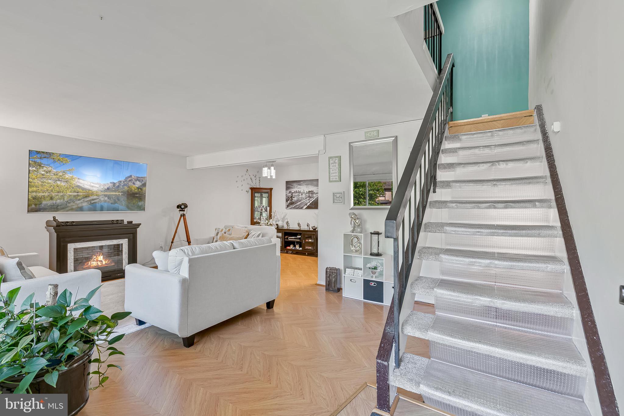 9108 Centerway Road Gaithersburg, MD 20879 - Photo 23 of 33 a living room with furniture and a fireplace