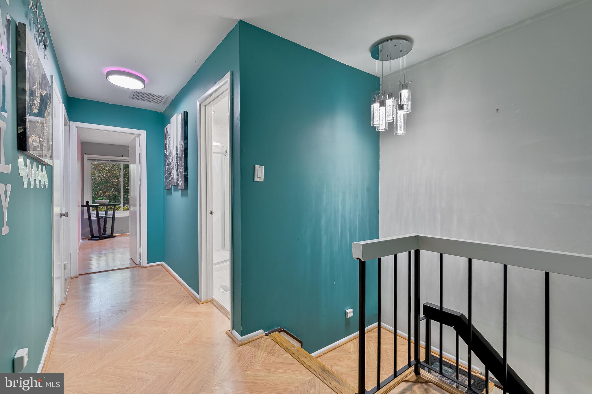 9108 Centerway Road Gaithersburg, MD 20879 - Photo 24 of 33 a view of a hallway and wooden floor and a kitchen