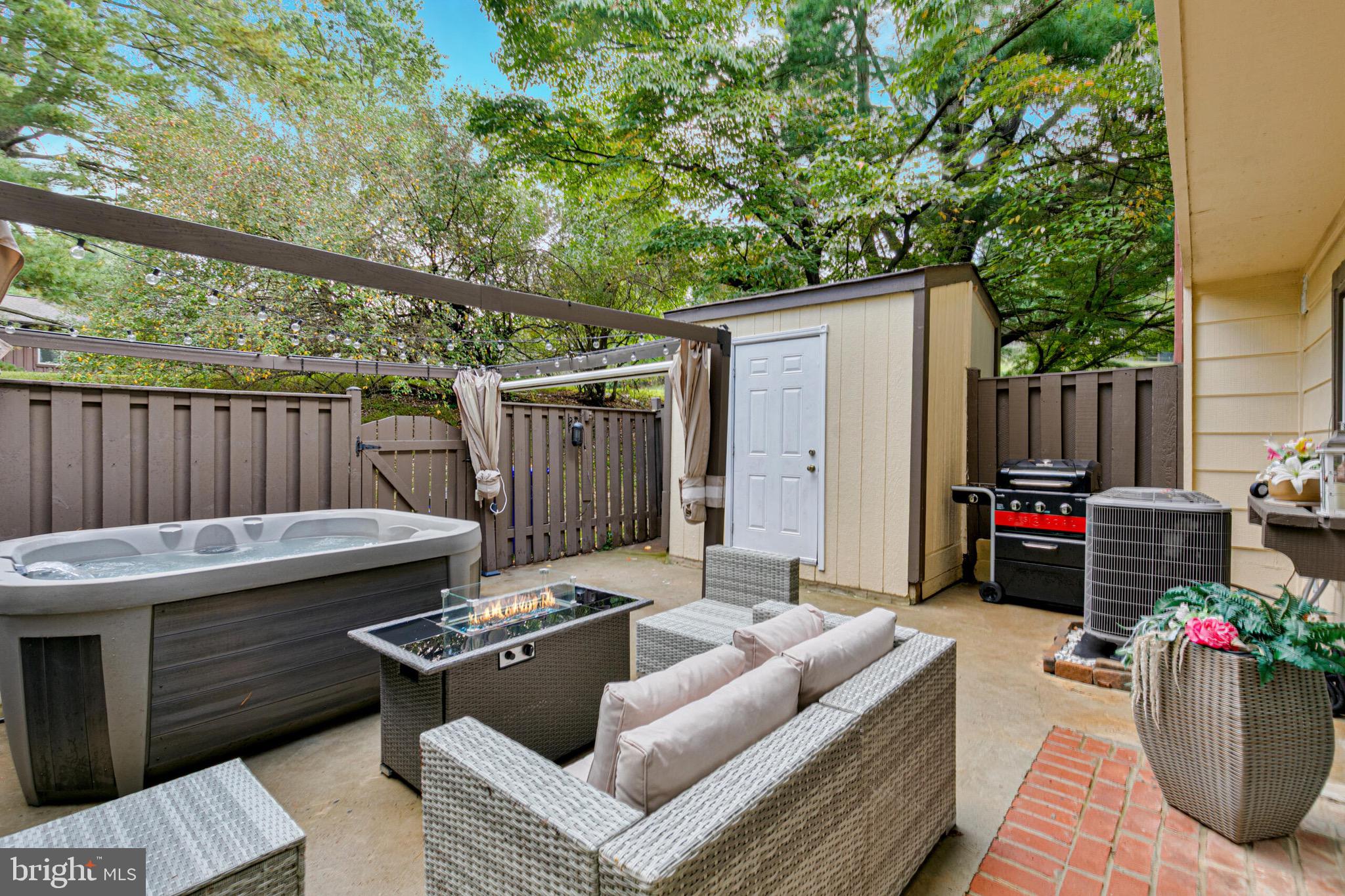 9108 Centerway Road Gaithersburg, MD 20879 - Photo 25 of 33 a view of a patio with couches table and chairs and potted plants