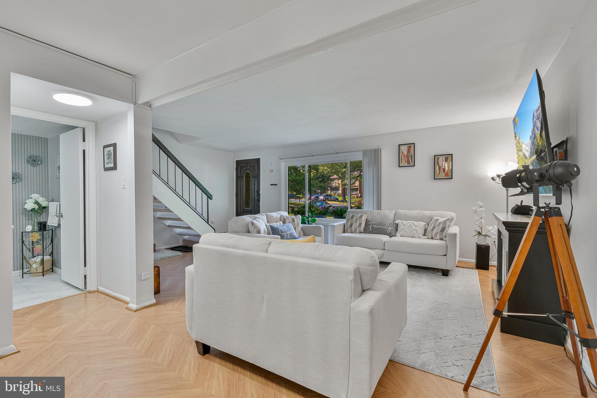 9108 Centerway Road Gaithersburg, MD 20879 - Photo 3 of 33 a living room with furniture a flat screen tv and a large window