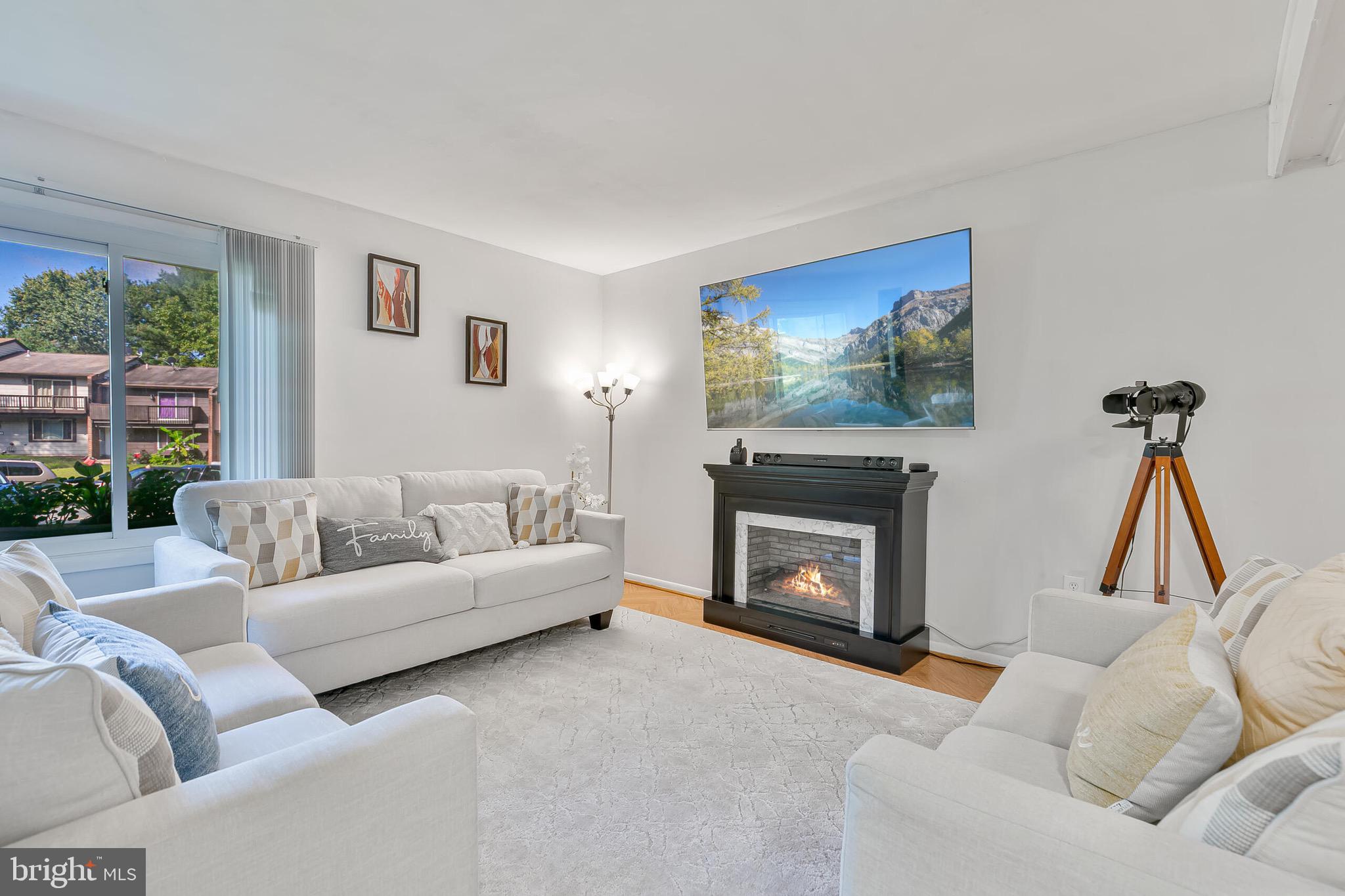 9108 Centerway Road Gaithersburg, MD 20879 - Photo 4 of 33 a living room with furniture and a fireplace