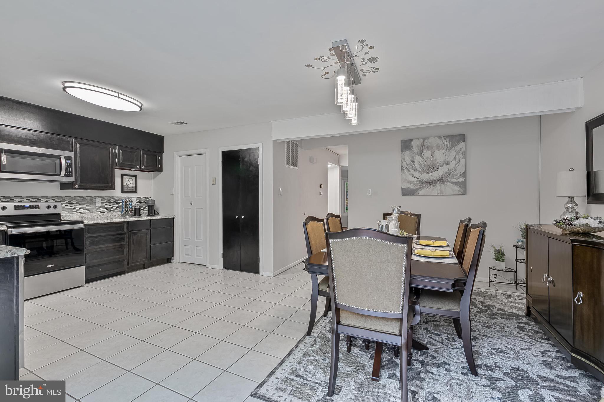 9108 Centerway Road Gaithersburg, MD 20879 - Photo 9 of 33 a view of a dining room with furniture