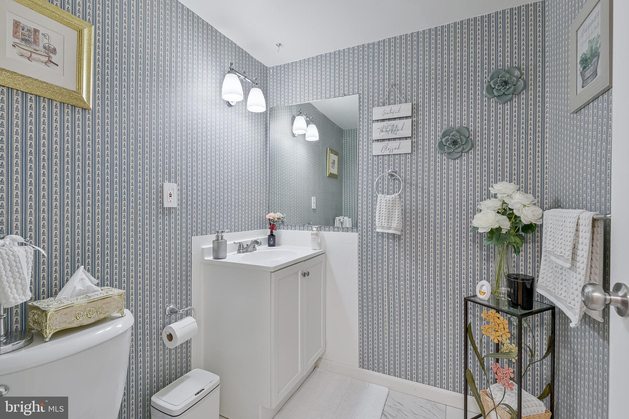 9108 Centerway Road Gaithersburg, MD 20879 - Photo 10 of 33 a bathroom with a sink toilet and mirror
