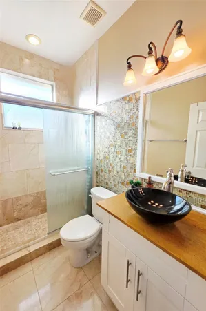 a bathroom with a toilet a sink and shower
