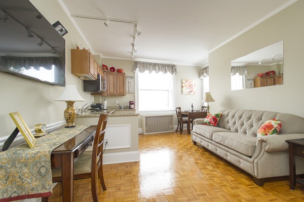 a living room with furniture and kitchen view