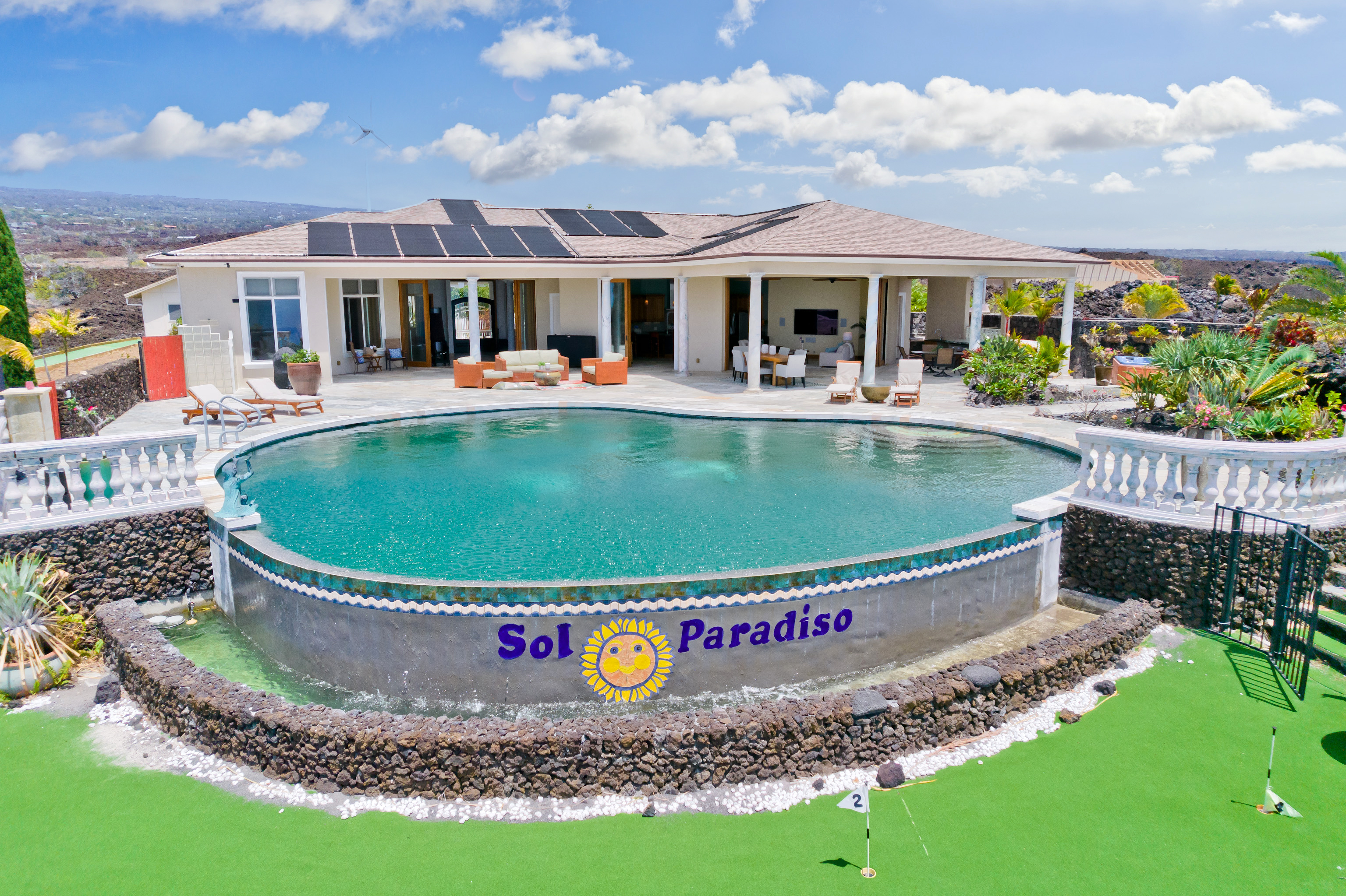 a view of a house with a swimming pool and a yard