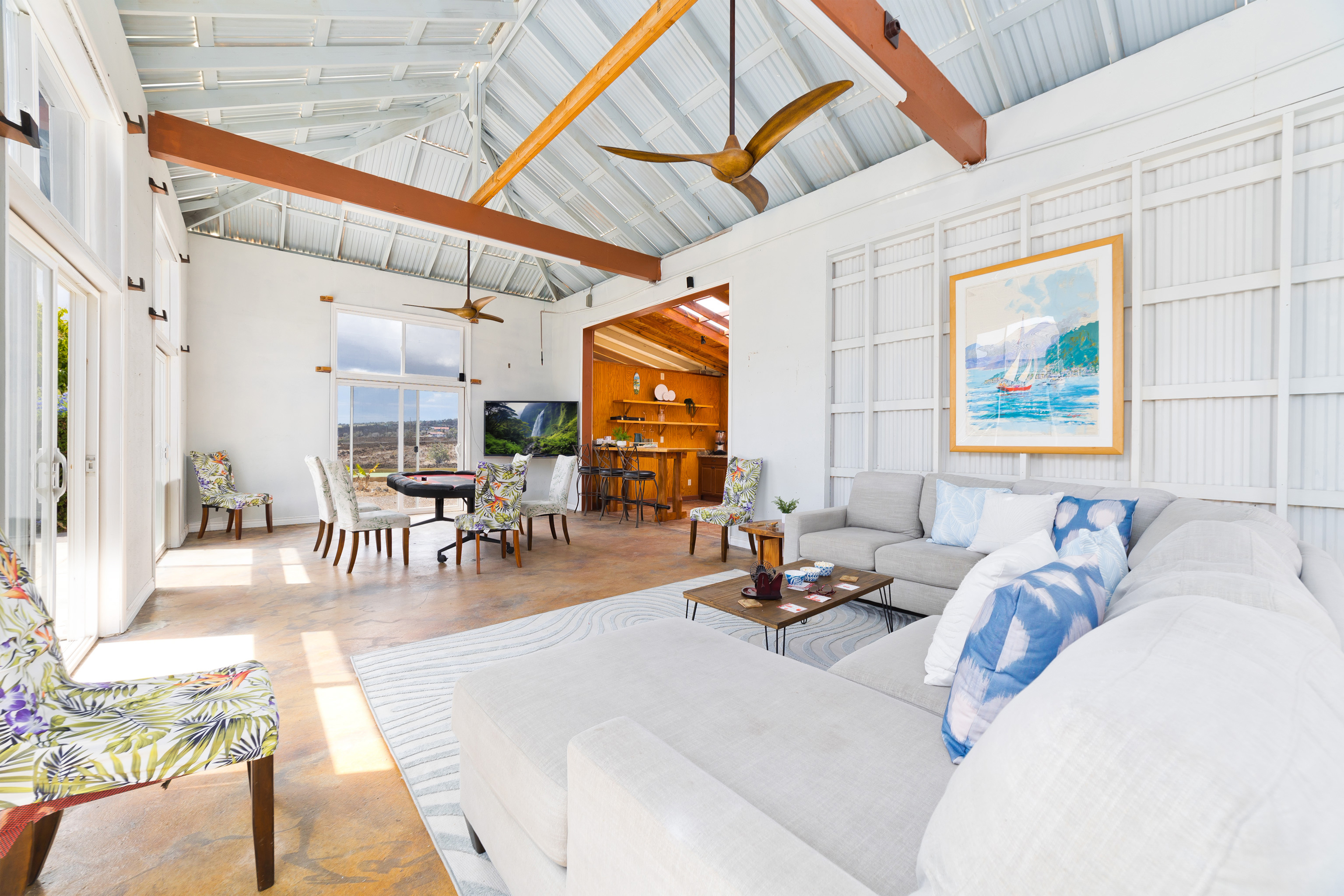 92-8322 Jacaranda Drive Ocean View, HI 96704 - Photo 23 of 30 a living room with furniture a wooden floor and a chandelier