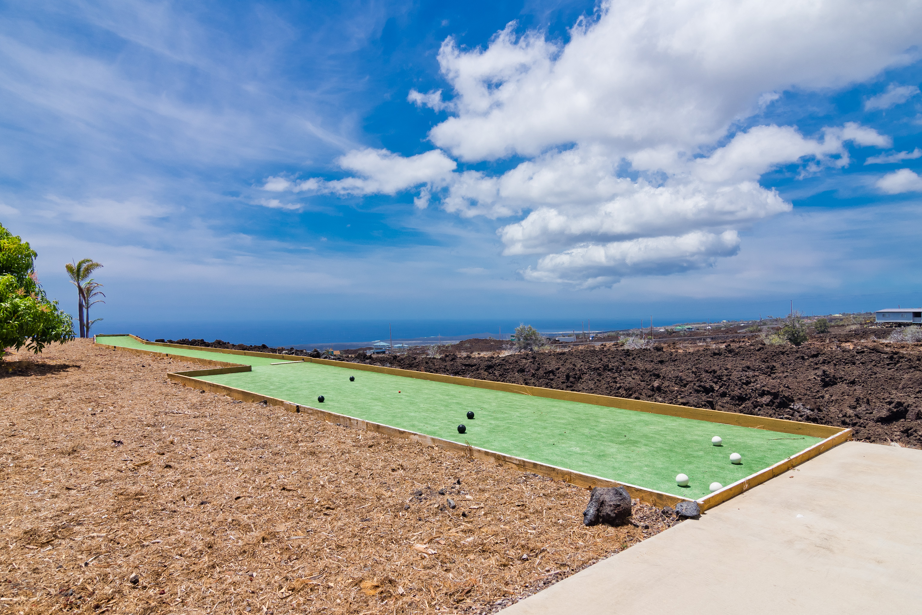 92-8322 Jacaranda Drive Ocean View, HI 96704 - Photo 28 of 30 a view of a field with a building in the background