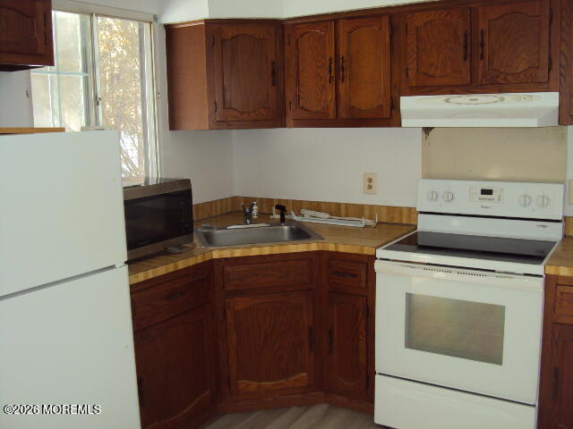 12 Spring Street, Unit D Whiting, NJ 08759 - Photo 11 of 14 a kitchen with a cabinets and a stove top oven