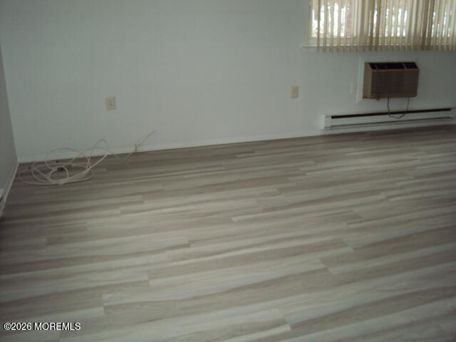 12 Spring Street, Unit D Whiting, NJ 08759 - Photo 4 of 14 a view of a livingroom with an empty space & wooden floor