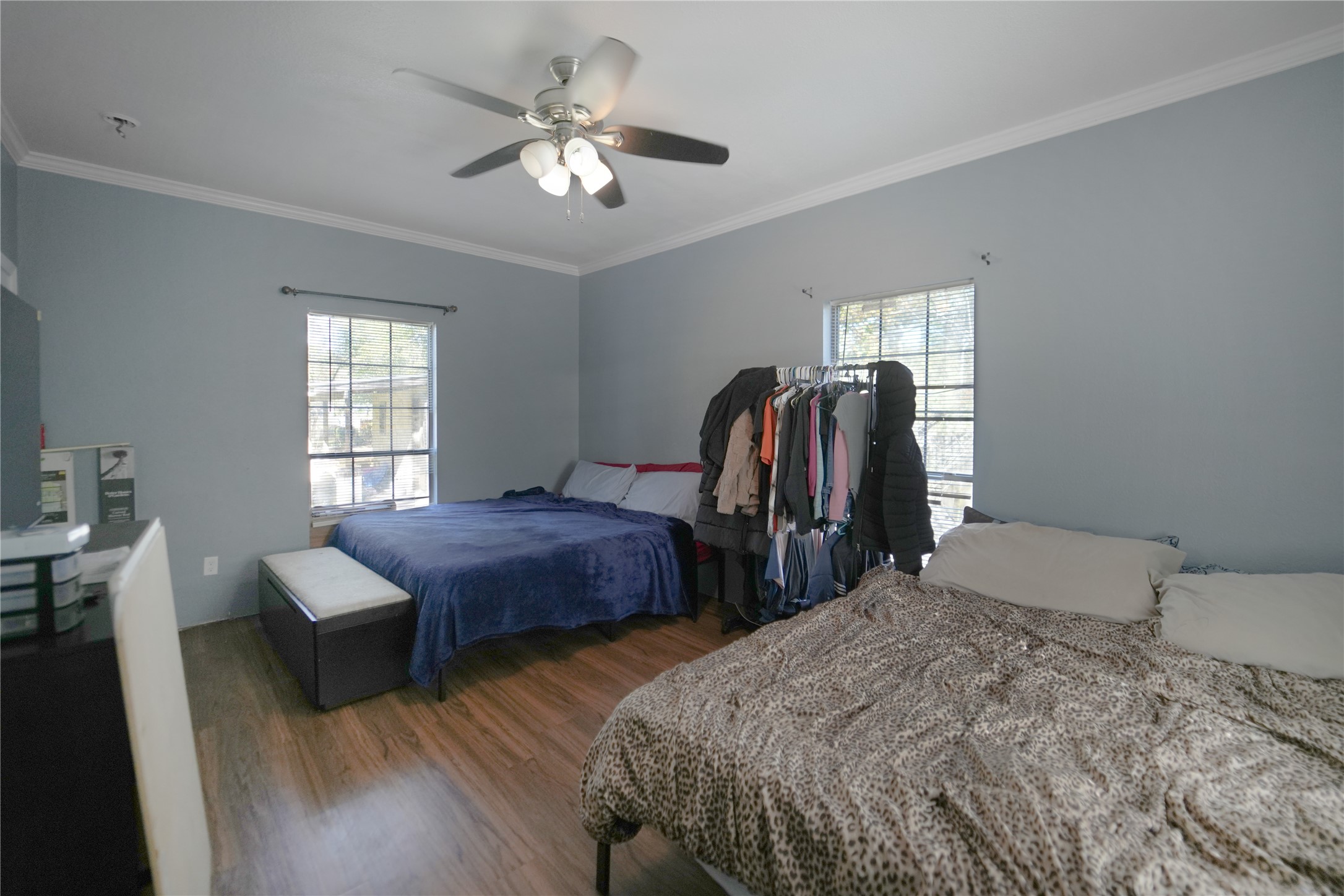 13475 5th Street Splendora, TX 77372 - Photo 11 of 16 a bedroom with two beds and a chandelier