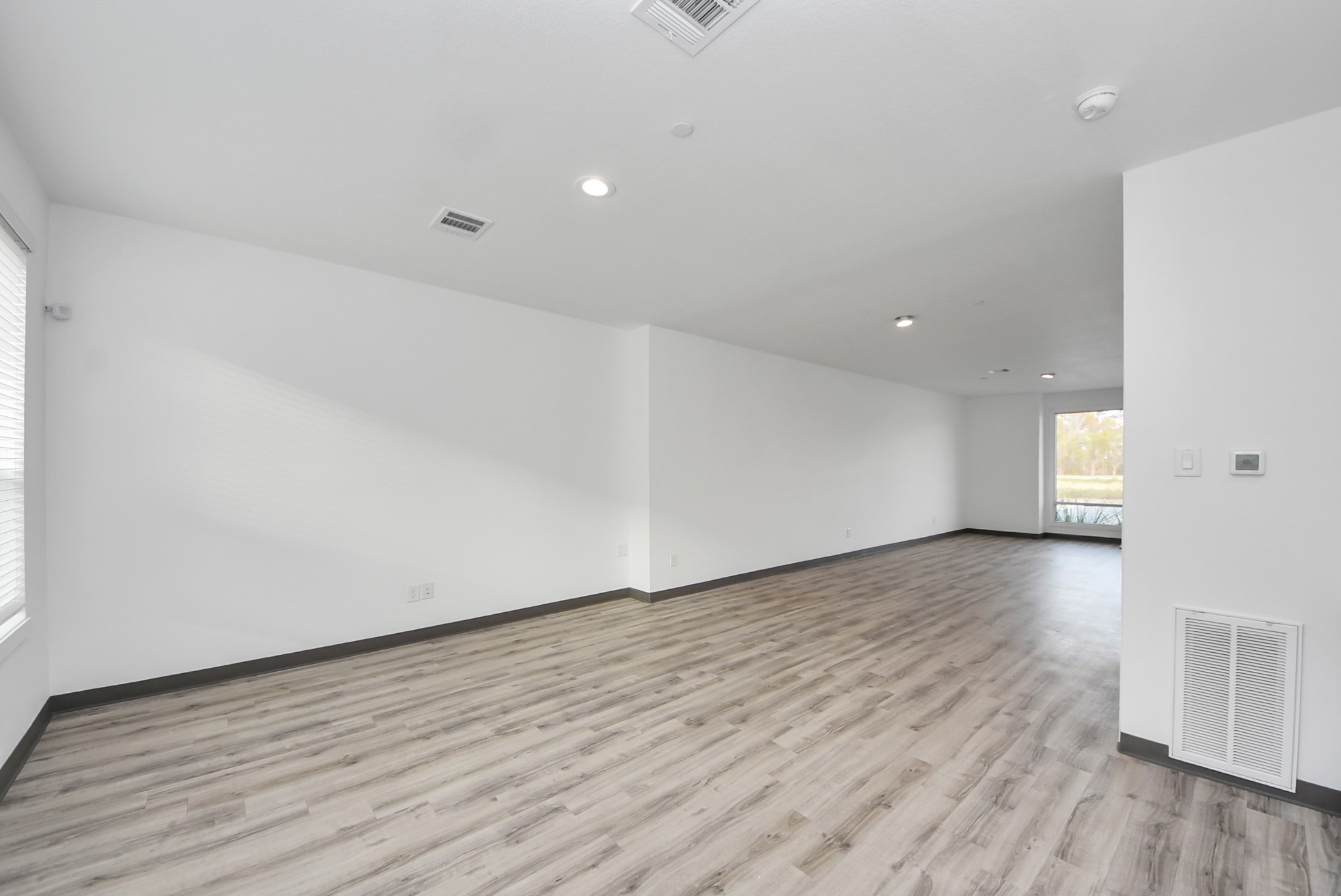 18716 Centro Main Street Conroe, TX 77385 - Photo 9 of 50 Additional open work zone ideal for conference tables, collaborative work areas, or private offices. Consistent modern finishes create a seamless flow throughout the commercial level.
