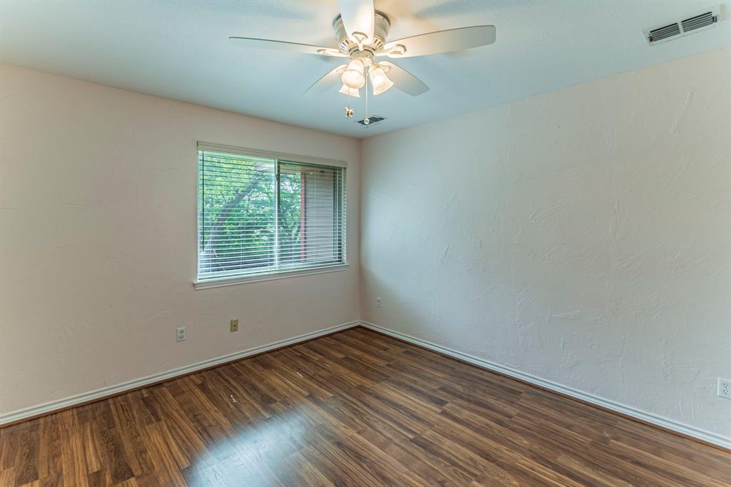 127 Nicklaus Nook Lancaster, TX 75146 - Photo 22 of 37 Spare room with ceiling fan, dark wood-type flooring, and a textured wall