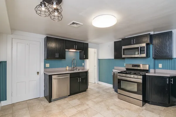 a kitchen with stainless steel appliances a stove sink and cabinets
