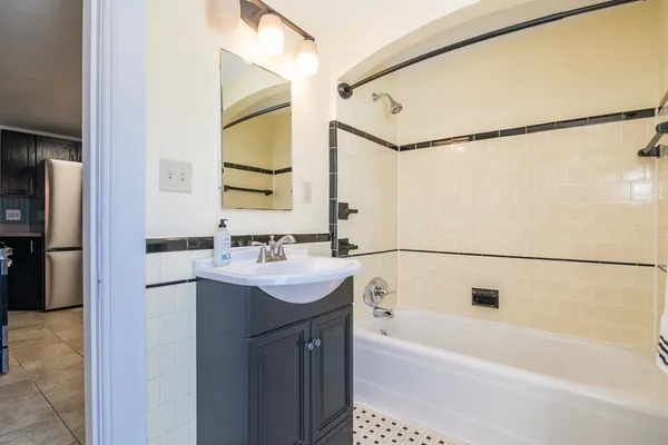 a bathroom with a bathtub and a sink