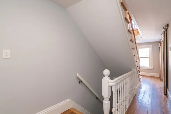 a view of a hallway with wooden floor