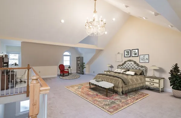 a bedroom with bed and a chandelier