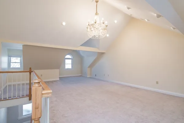 wooden floor in an empty room with a chandelier