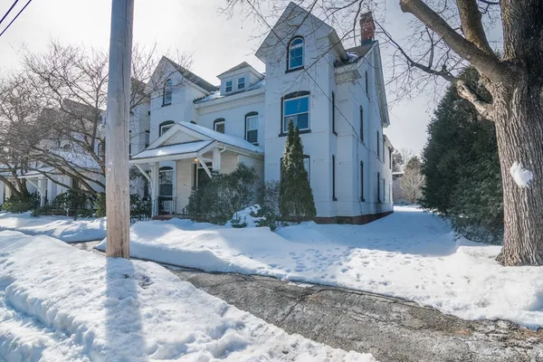 a view of a house with a snow in the yard