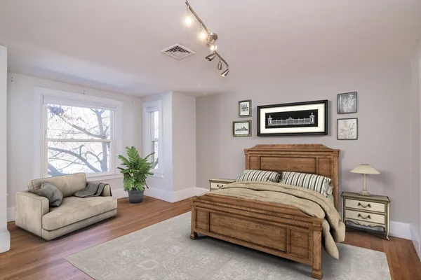 a bedroom with a large bed and a couch