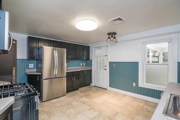 a kitchen with a refrigerator and a sink