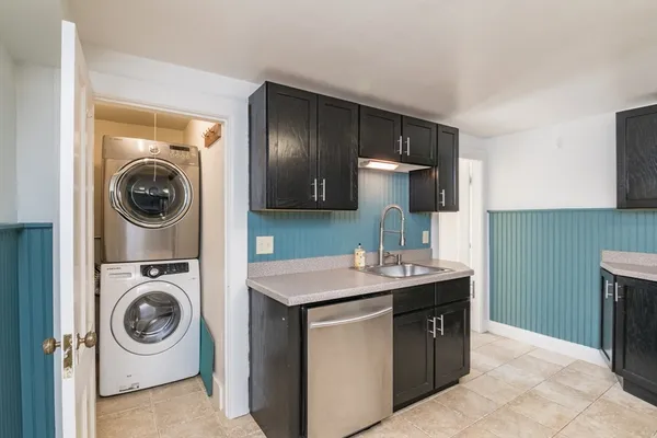 a utility room with sink dryer and washer