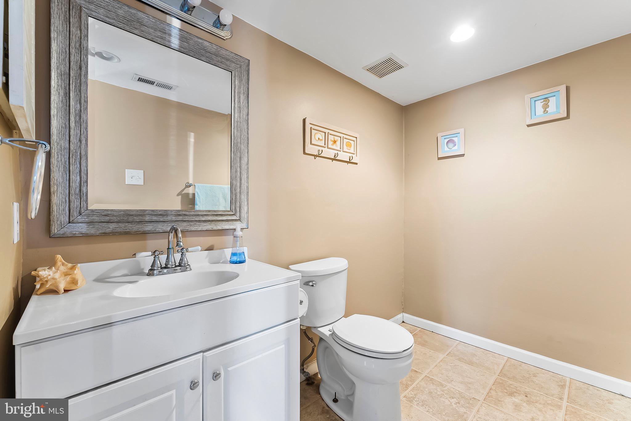 223 Stirrup Road Swedesboro, NJ 08085 - Photo 17 of 30 a bathroom with a sink mirror vanity and toilet