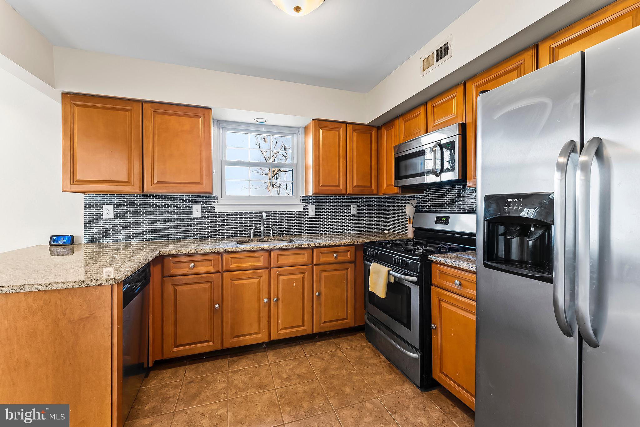 223 Stirrup Road Swedesboro, NJ 08085 - Photo 10 of 30 a kitchen with stainless steel appliances granite countertop a stove a sink and a refrigerator