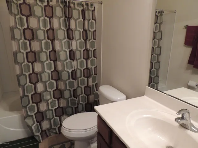 a white toilet sitting next to a bathroom sink