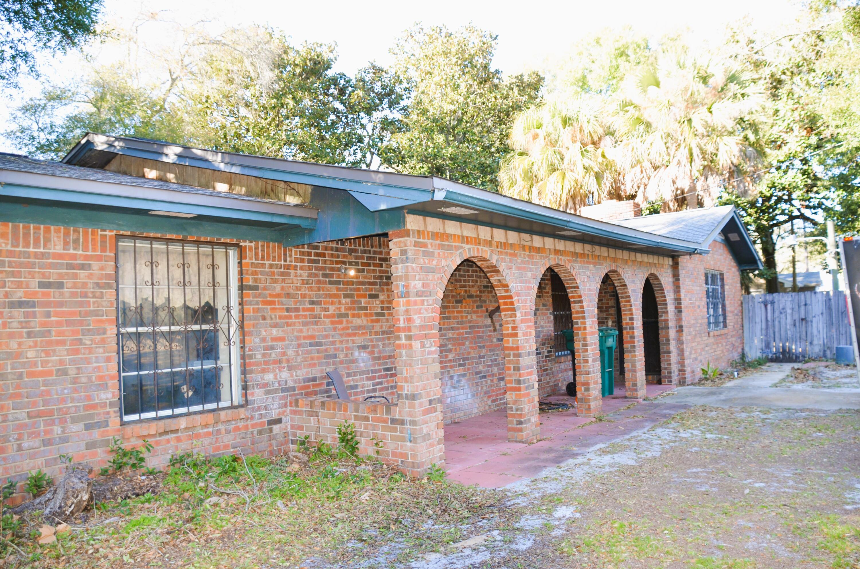 515 Beach Drive Destin, FL 32541 - Photo 2 of 43 a backyard of a house with lots of green space