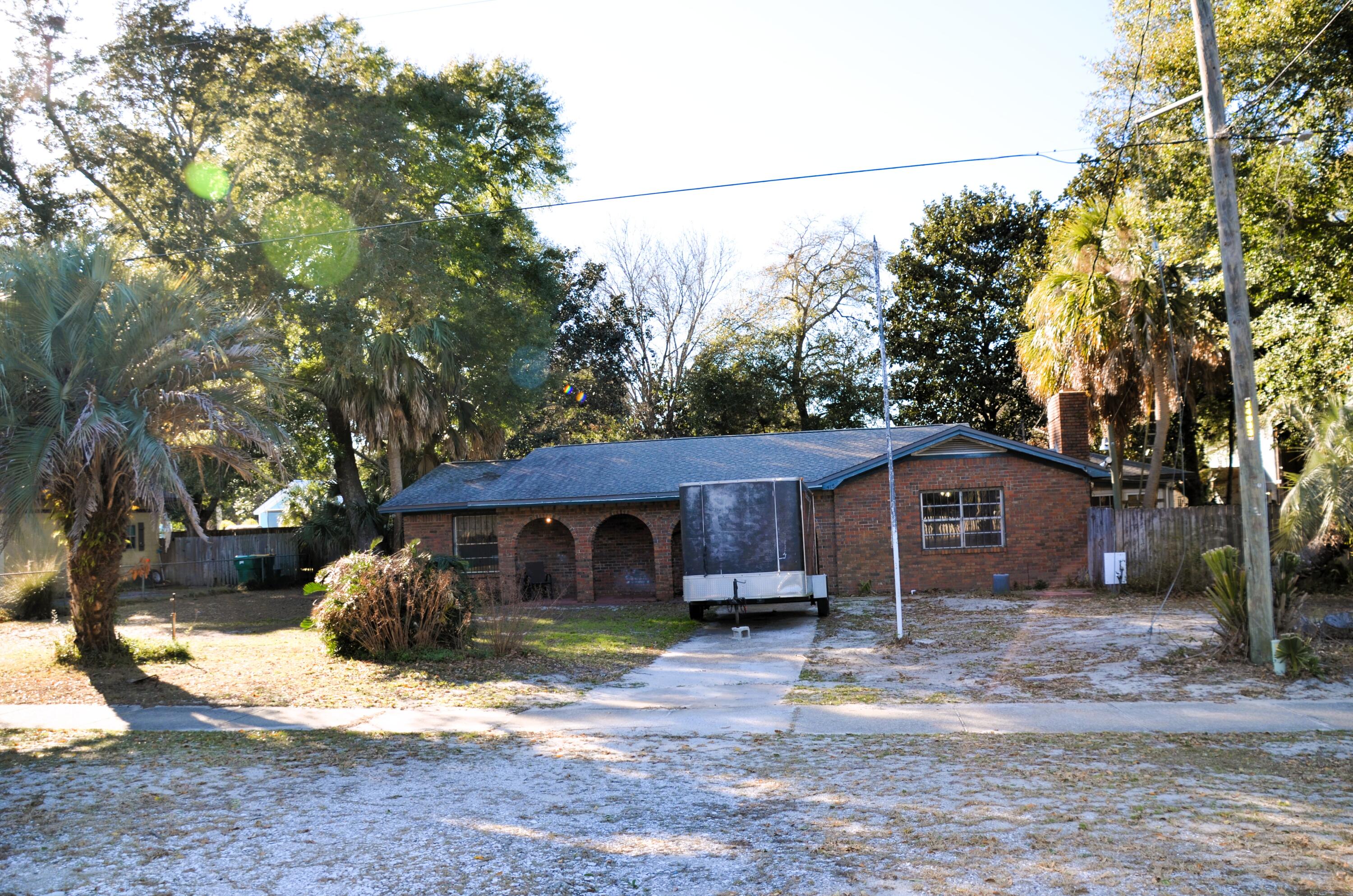 515 Beach Drive Destin, FL 32541 - Photo 36 of 43 a front view of a house with a yard and large tree