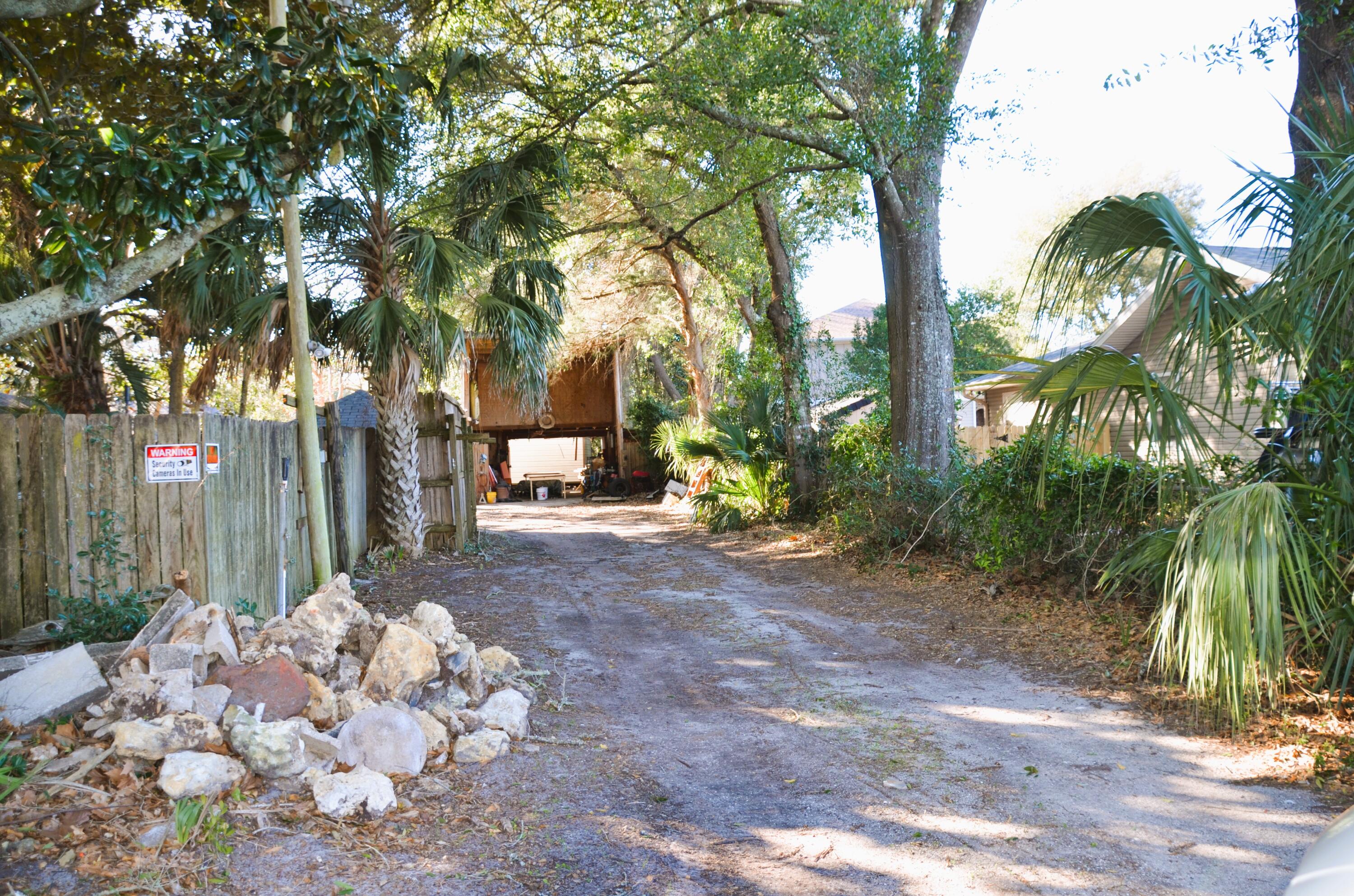 515 Beach Drive Destin, FL 32541 - Photo 39 of 43 a view of backyard with a trees