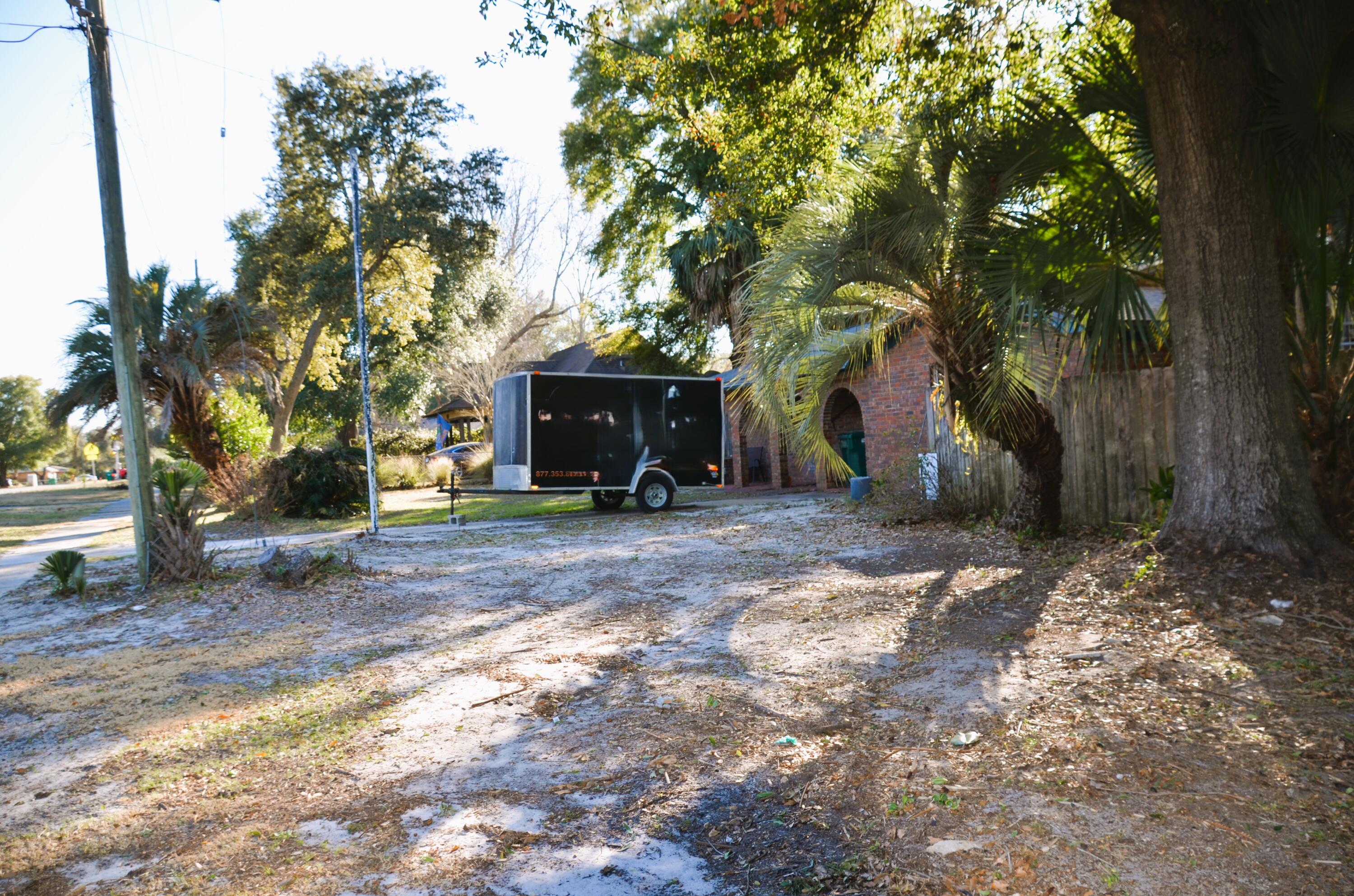 515 Beach Drive Destin, FL 32541 - Photo 41 of 43 a view of a yard with plants and a trees