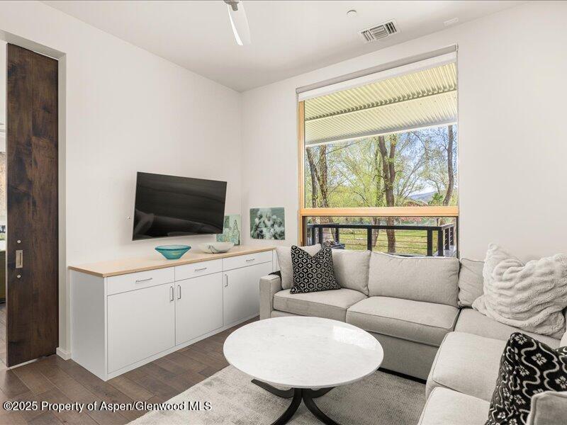 102 Evans Road, Unit 107 Basalt, CO 81621 - Photo 18 of 25 a living room with furniture a flat screen tv and a large window