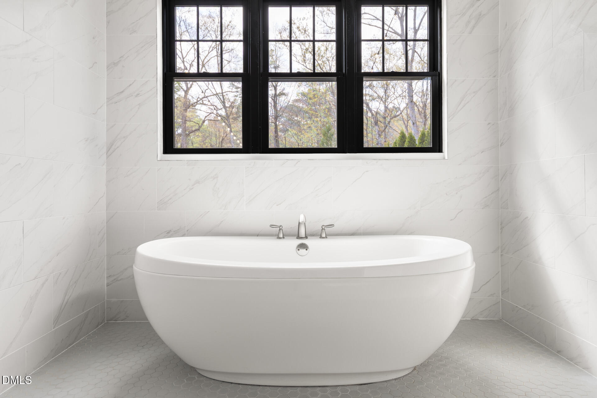 1117 Barley Stone Way Raleigh, NC 27603 - Photo 27 of 59 a white bath tub sitting in a bathroom next to a window