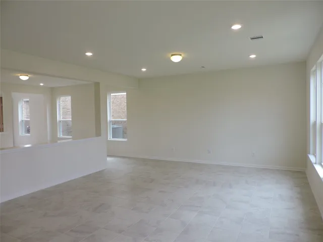 a kitchen with stainless steel appliances granite countertop a sink a refrigerator and a refrigerator