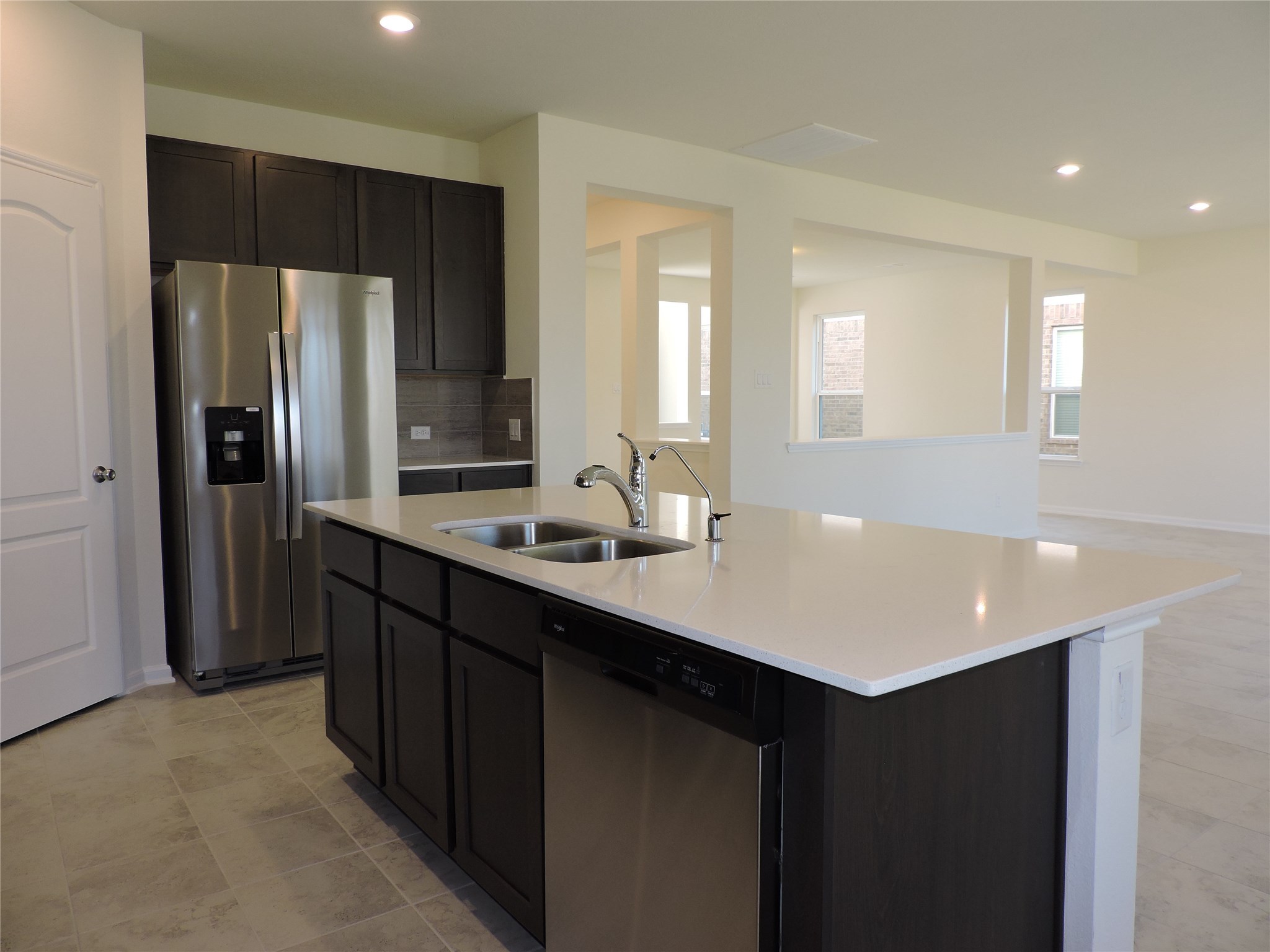 1122 Epworth Ct. Conroe, TX 77304 - Photo 12 of 35 a kitchen with stainless steel appliances granite countertop a sink a refrigerator and a refrigerator
