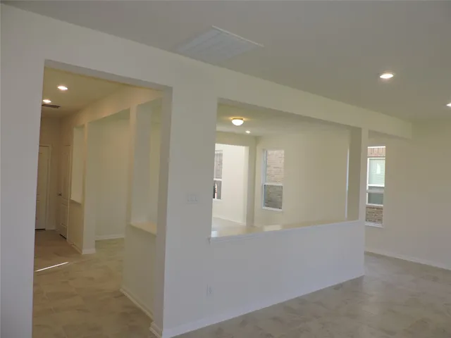 an empty room with windows and entrance