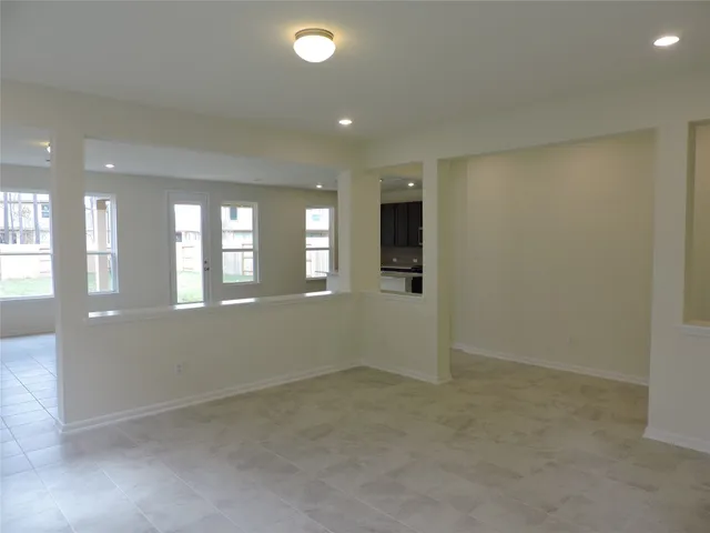 an empty room with windows and entrance